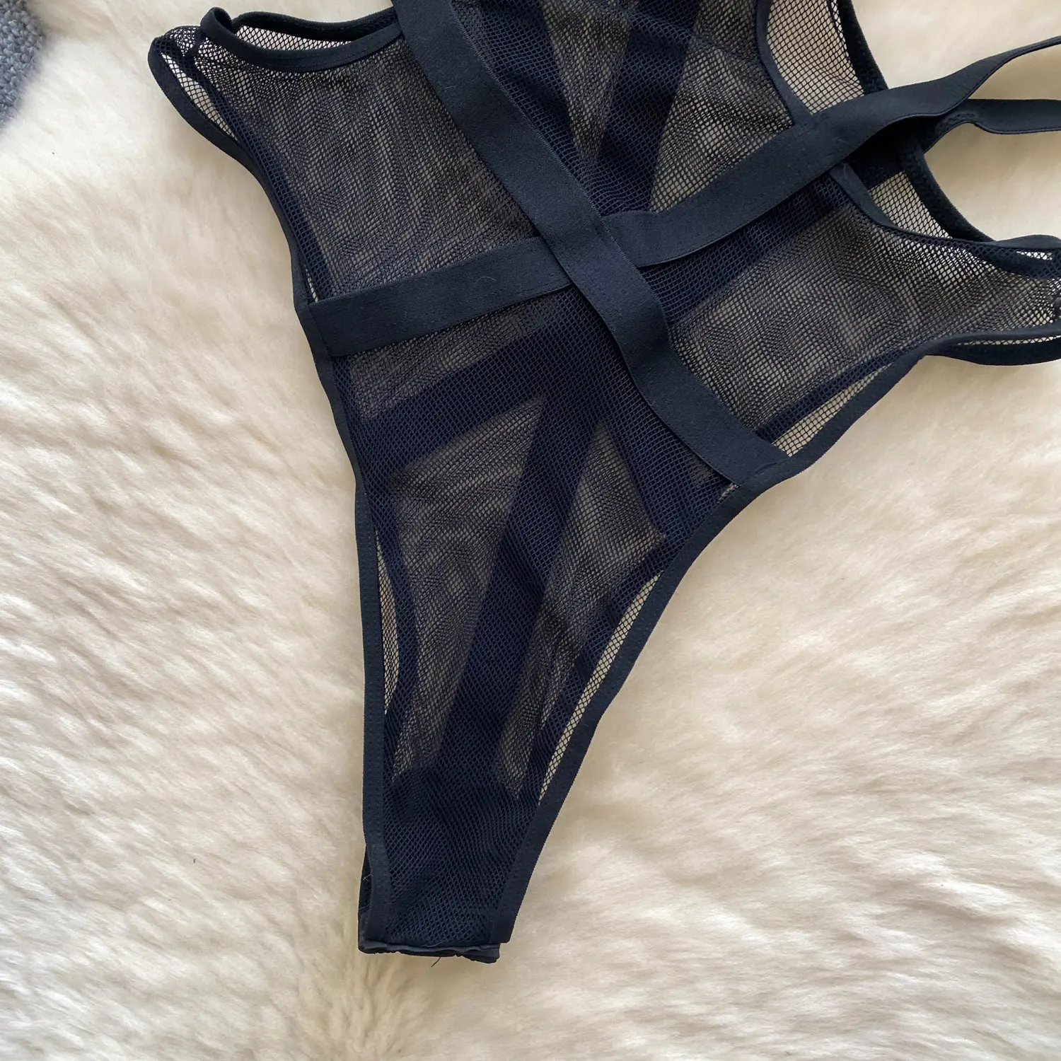 black bodysuit with transparent mesh and cut sides