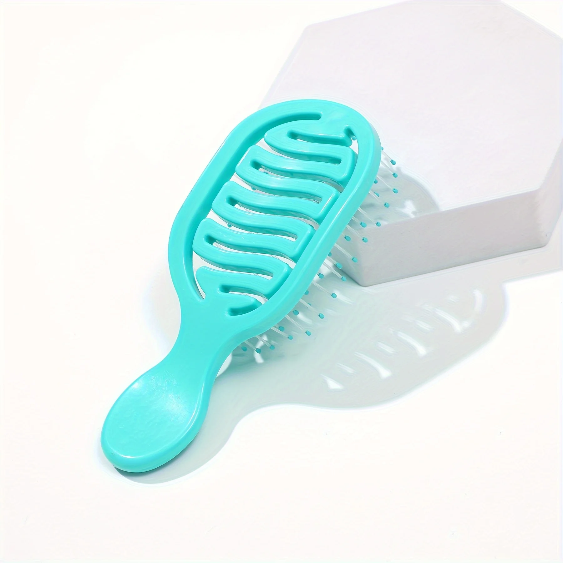 Mini Track Hairbrush, portable hollow design with nylon bristles, ergonomic handle, compact and lightweight—a travel essential.