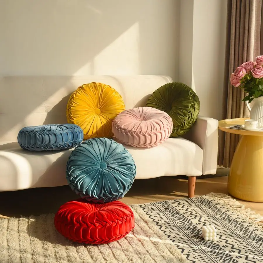 Two ruched velvet pillows on a chair
