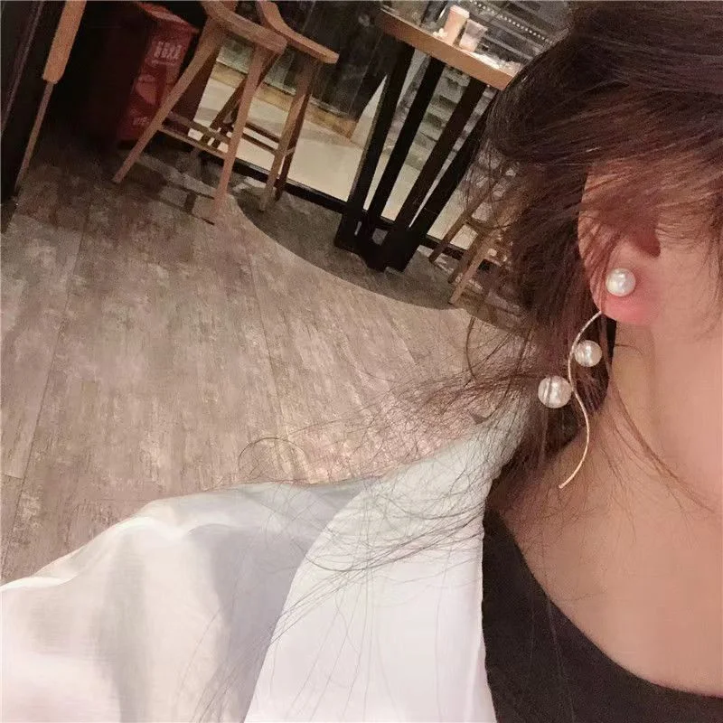 Close-up of pearl and gold-tone details on the earrings