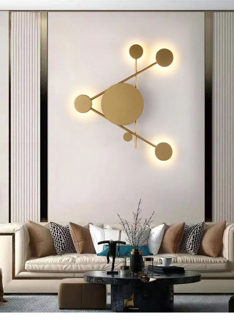 A minimalist living room featuring a wall sconce in matte gold.