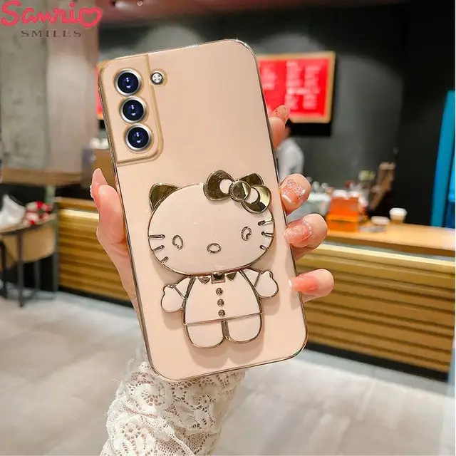 Upgrade your phone case game and let Hello Kitty accompany you wherever you go with the Kawaii Hello Kitty Makeup Mirror Holder Phone Case.