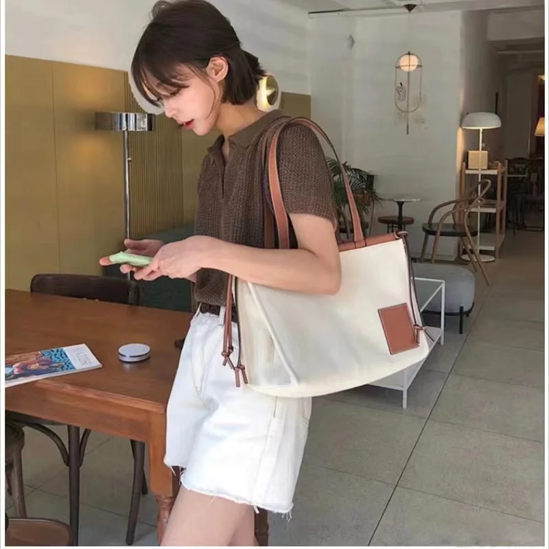 

Canvas Imported Cowhide Blend Drawstring Design Tote Bag Stylish Combination of Functionality and Quality Leather Craftsmanship