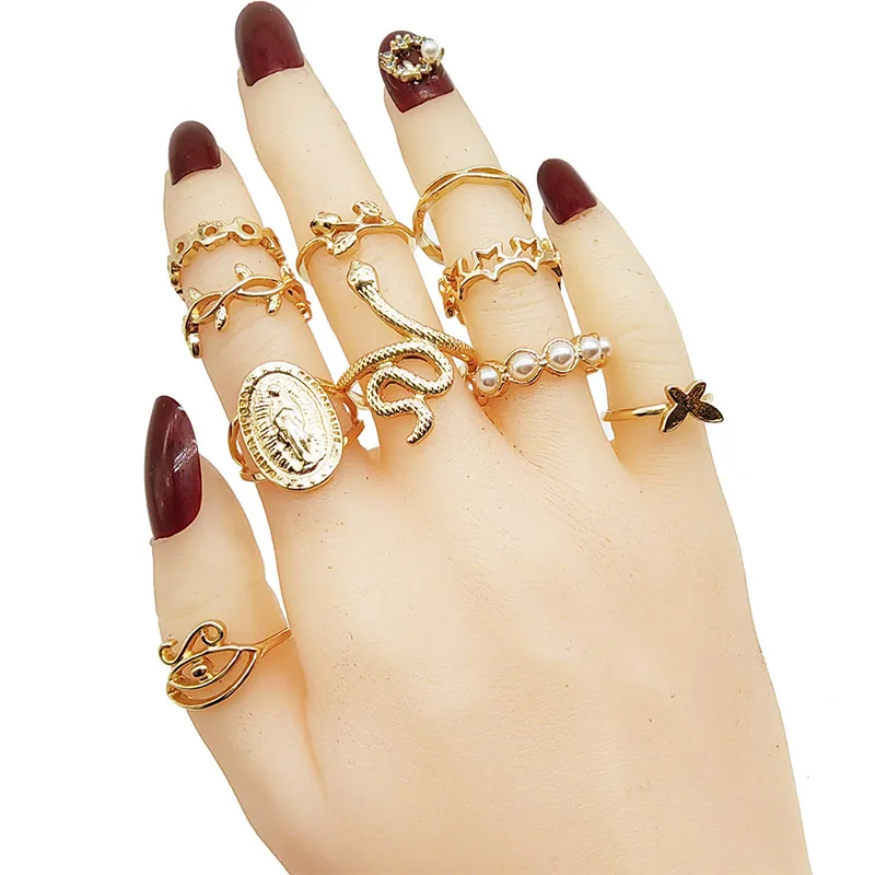 Assortment of gold colored rings with butterfly and floral patterns