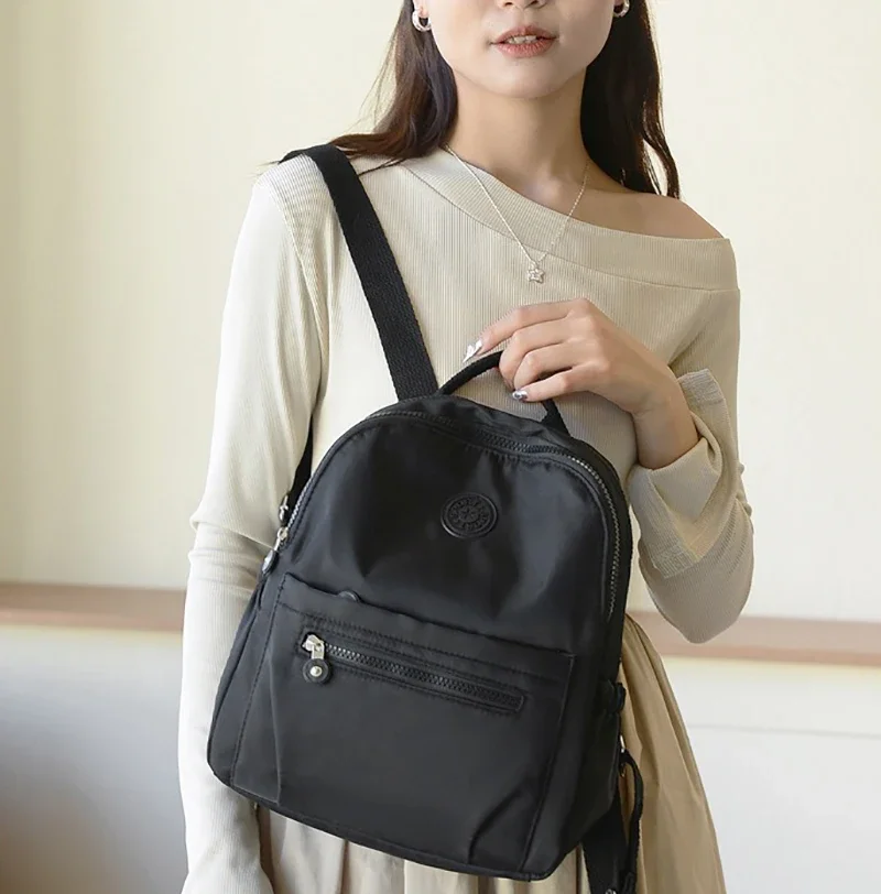 حقيبة ظهر كورية من النايلون للنساء كاجوال بلون سادة حقيبة مدرسية صغيرة حقيبة سفر للطلاب المراهقين حقيبة ظهر مدرسية للأم