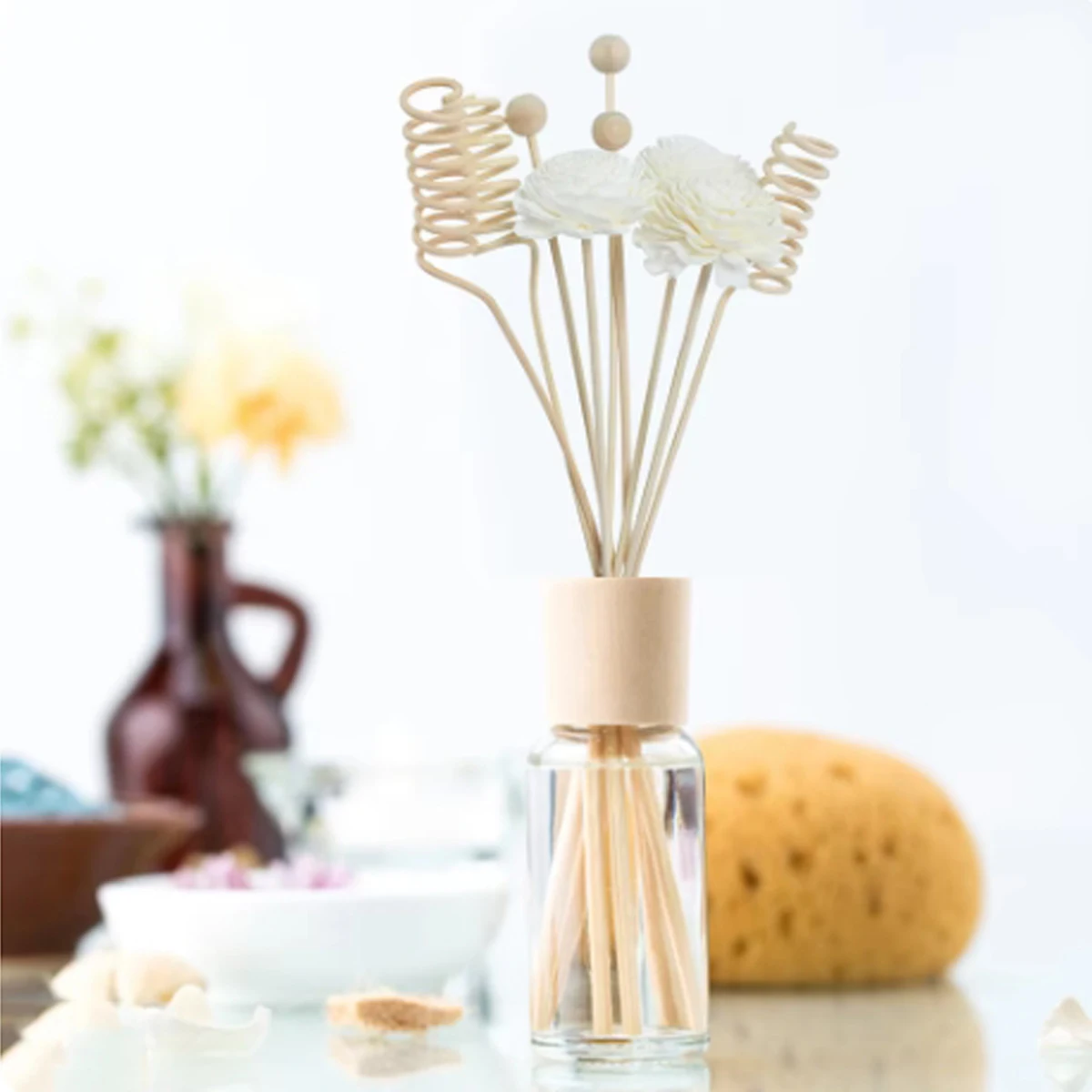 Close-up of flower rattan diffuser sticks with decorative tops