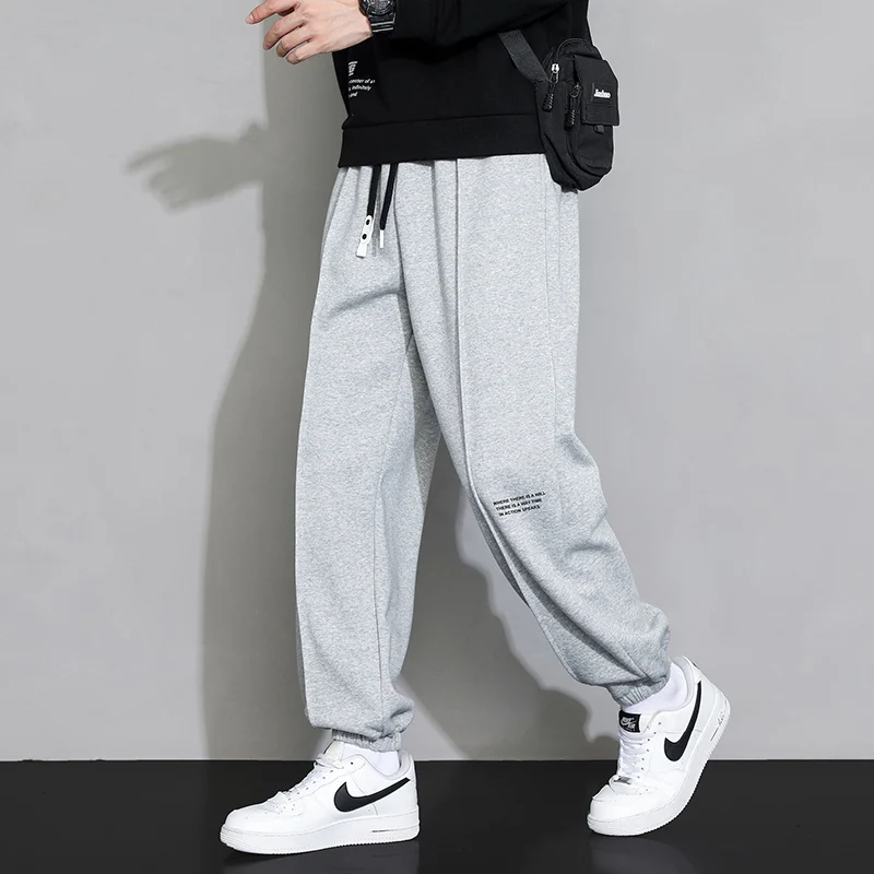 

2024 Autumn and Winter Men's Elastic Waist Panel Pocket Letter Fashion Solid Color Tie Feet Loose Sports Versatile Casual Pants