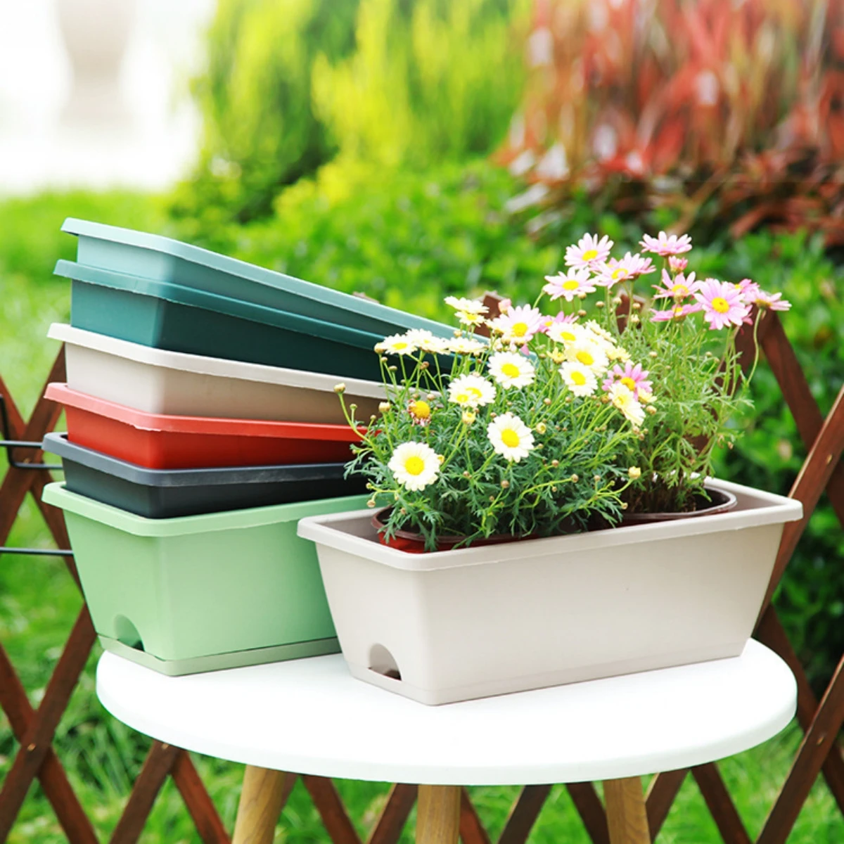 Another view of the planter with plants, highlighting its modern style.