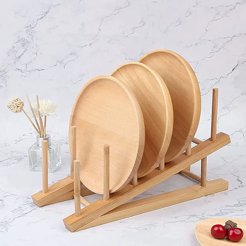 Bamboo rack in use holding cups lids and kitchen utensils on countertop