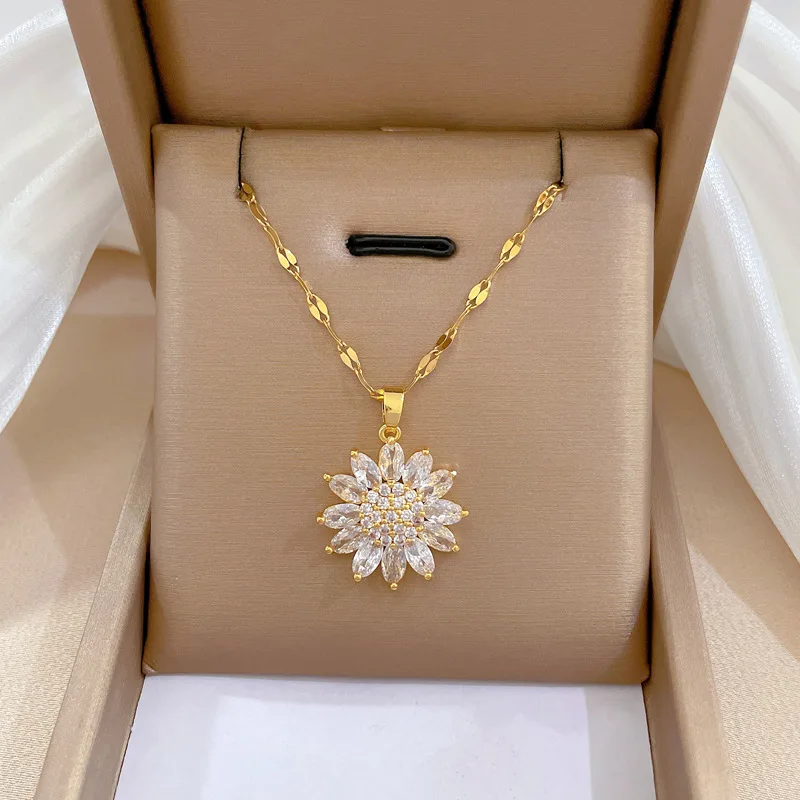 Collier fleur blanche perlé en acier inoxydable posé dans une boite de bijoux 