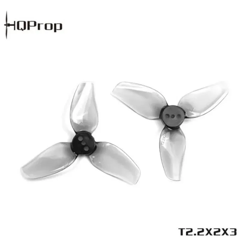 Deux hélices de drone FPV HQProp T2.2x2x3 3 pales grises, une CW et une CCW, côte à côte.