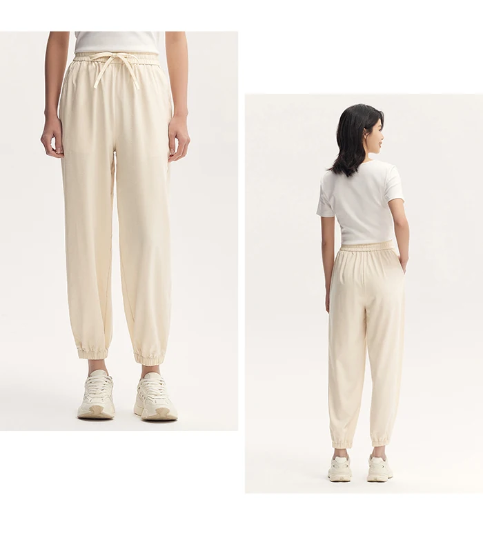 Pantalones casuales para mujer diseñados con un toque de textura. Pantalones cónicos de jacquard con estampado oscuro y un ajuste único y holgado.