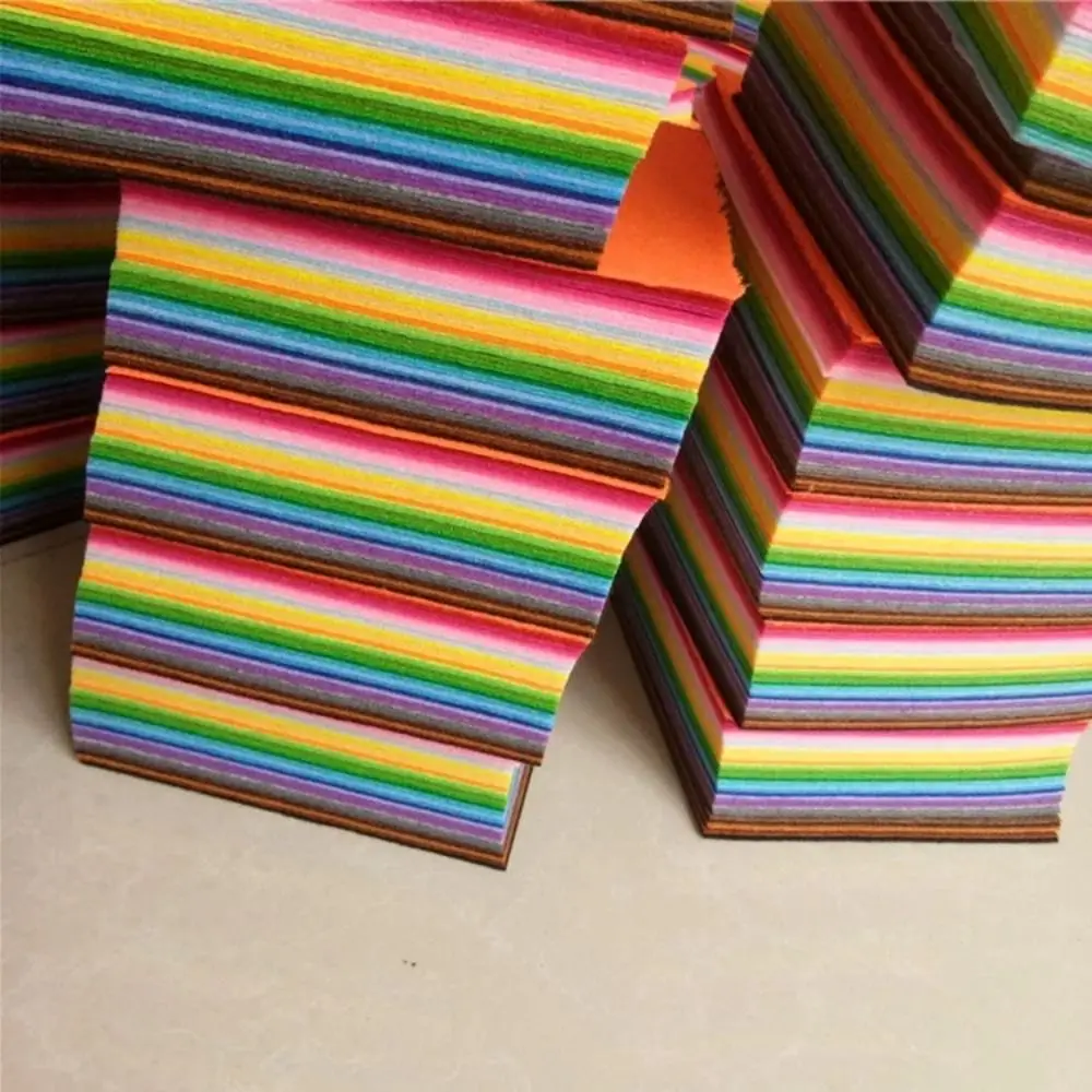 Hands crafting with colorful felt squares