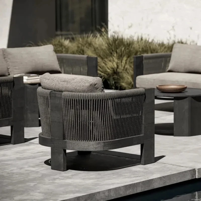 Outdoor garden armchair made of teak wood and woven acrylic, the fabric used for the cushions is waterproof and UV resistant.