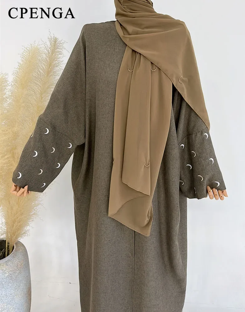 brown coat and hijab