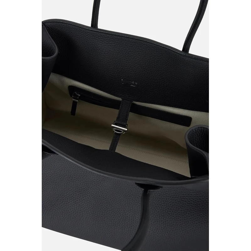 he Leather Tote bag is made of cowhide and designed for commuters, featuring a textured travel bag for women.