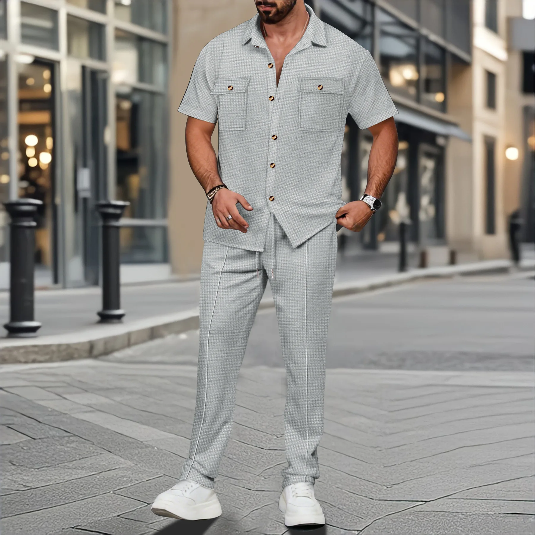 Men’s solid color waffle check short sleeve shirt and trousers two-piece set displayed on model in outdoor travel setting gray