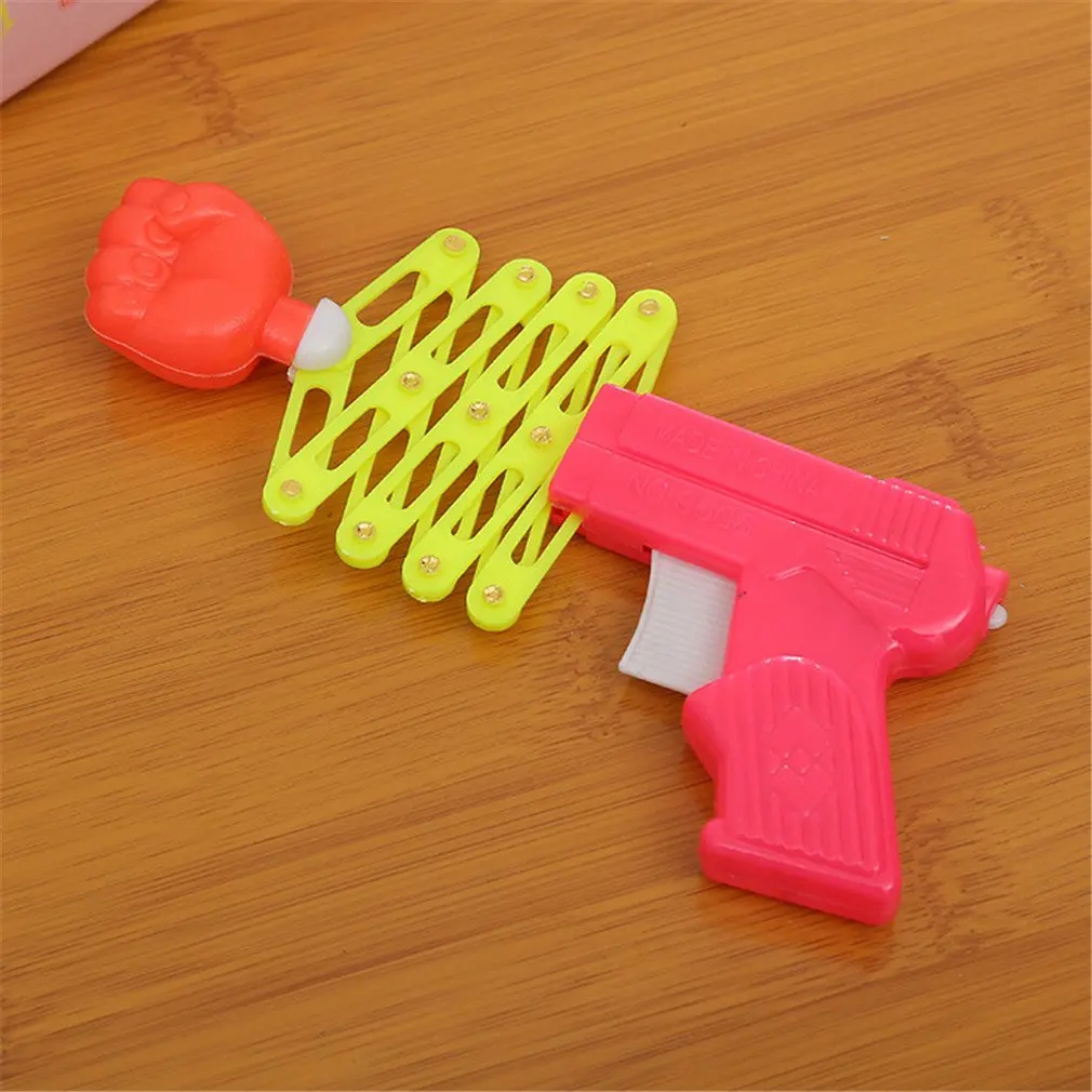 Sf50faf3a6d90439c83e2252b0e791ce1b Hot Funny Retractable Fist Shooter Trick Toy Funny Child Kids Plastic Party Festival Gift Classic Elastic Telescopic Fist Toy