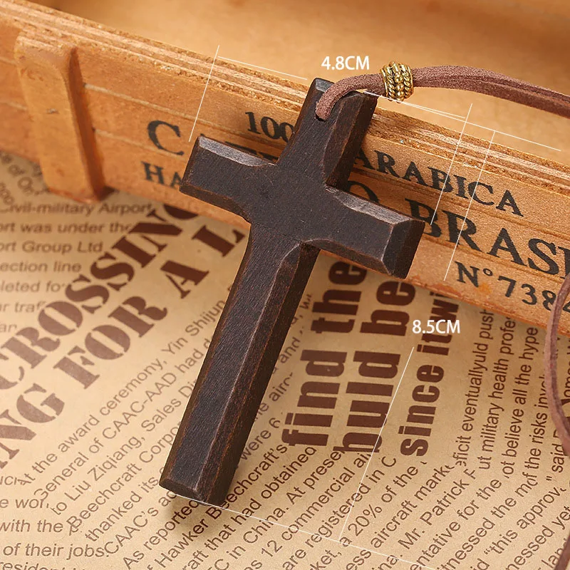 Wooden cross pendant necklace in black with 80cm cord, displayed on vintage paper background.