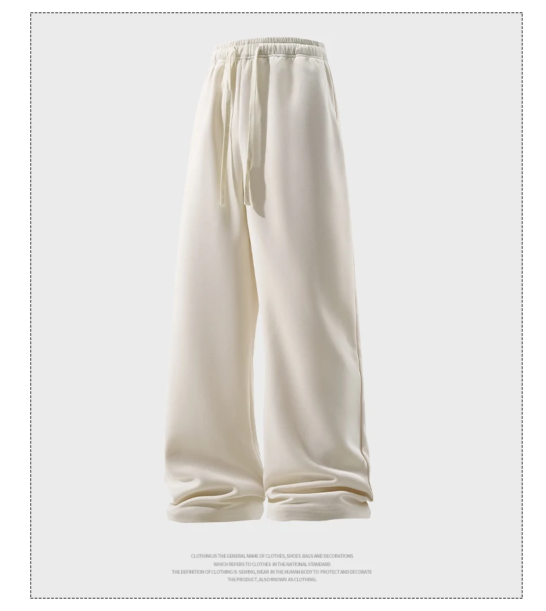 Man wearing loose wide-leg sweatpants with drawstring waist in a casual autumn streetwear setting beige