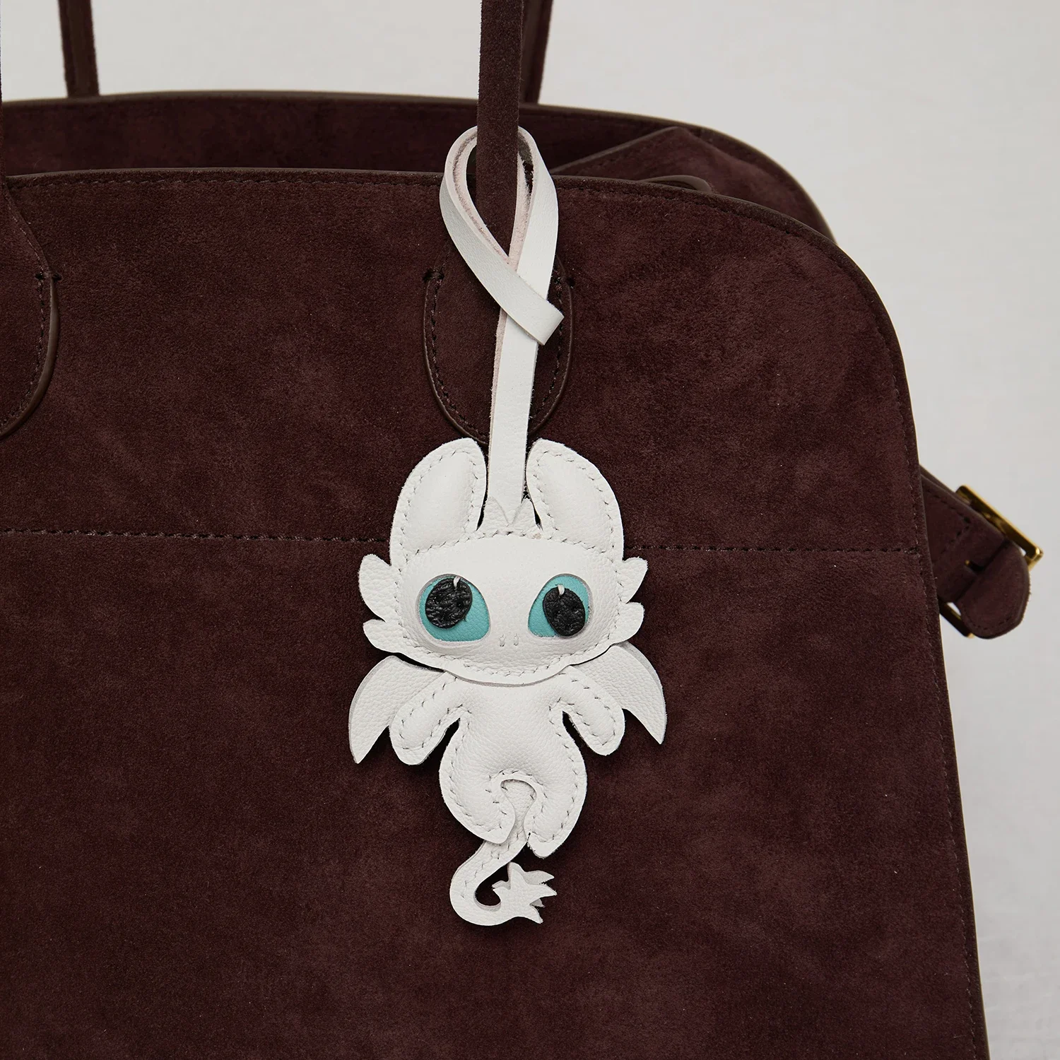 Dragon leather charm hanging on handbag