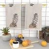 2 soft towels with abstract art plant patterns, stylish beige and black leaf designs, suitable for kitchens, bathrooms, or gyms 2
