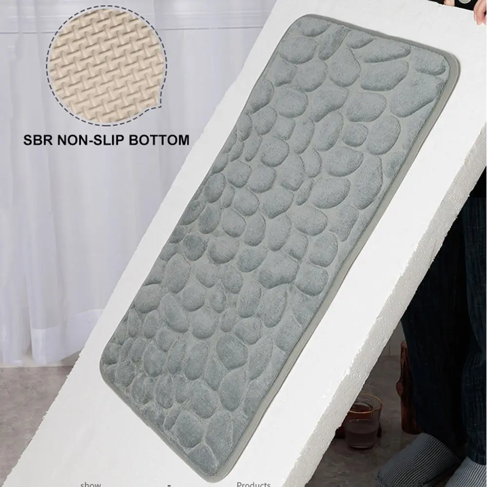 Cobblestone embossed gray bath mat with non-slip backing, placed in a modern bathroom.