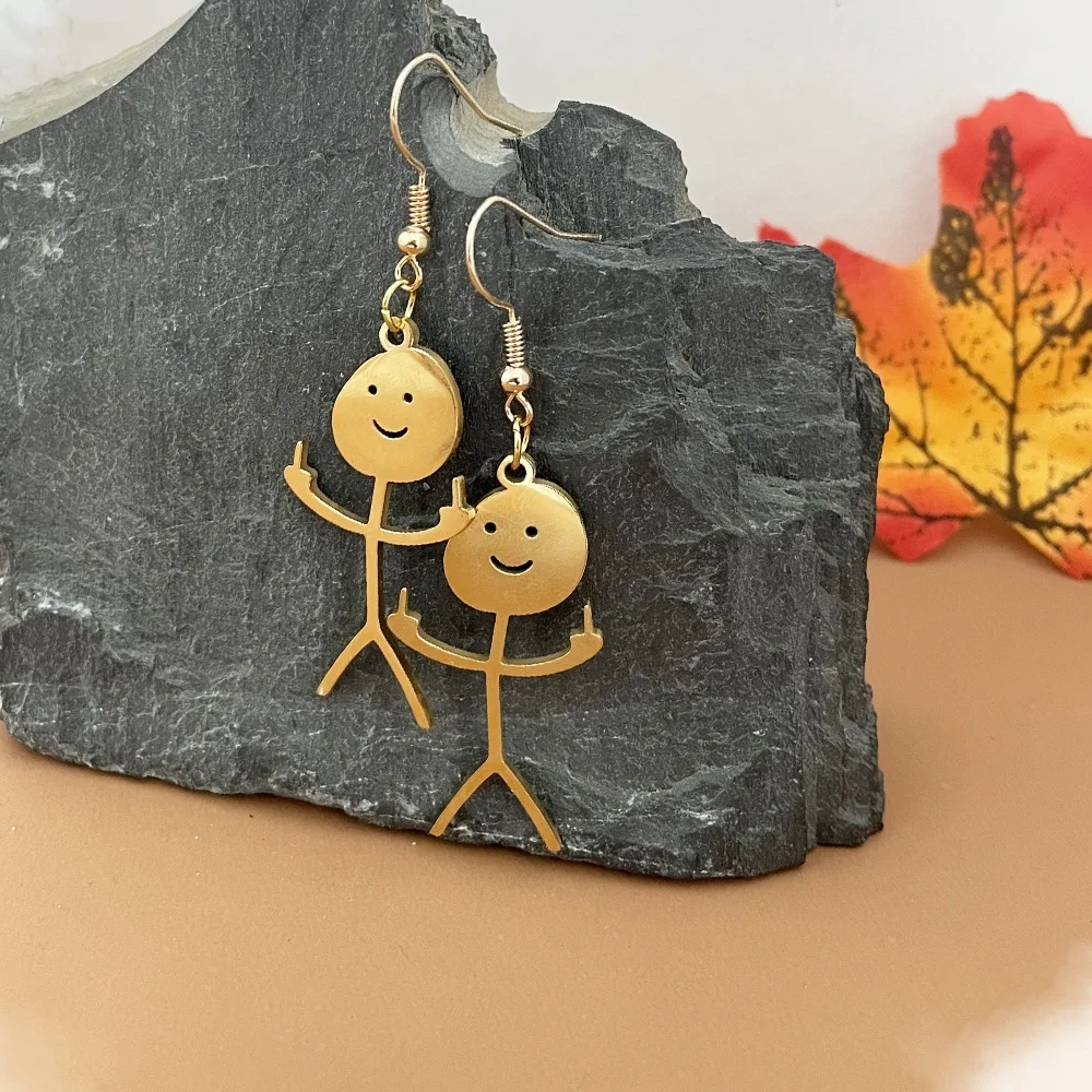 Creative Doodle Pendant Earrings are a creative pair of pendant earrings featuring gold stick figure doodles on a rock.