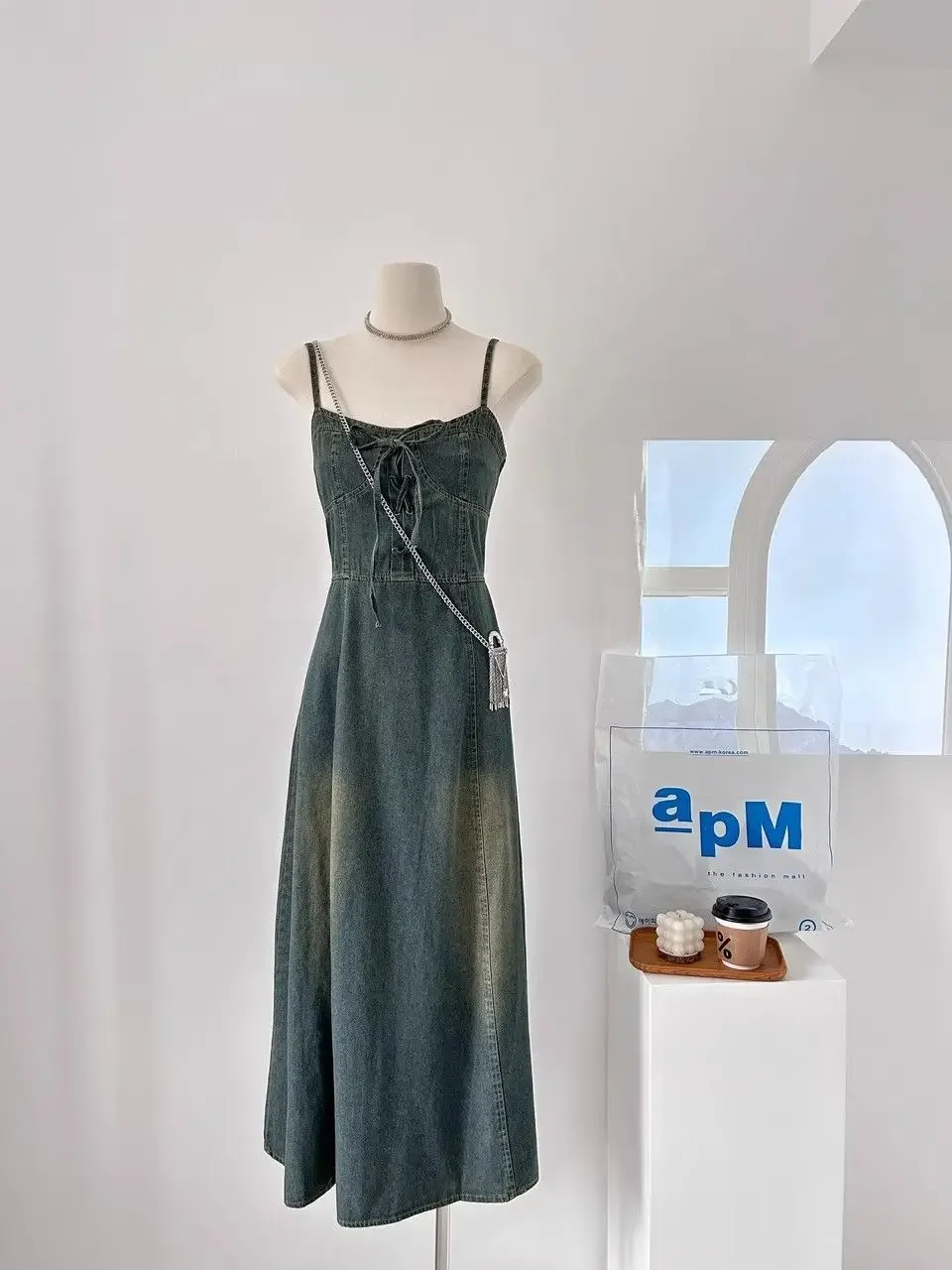 

A vintage-inspired denim dress with a distressed wash color is the latest addition to summer fashion. This new style 2024