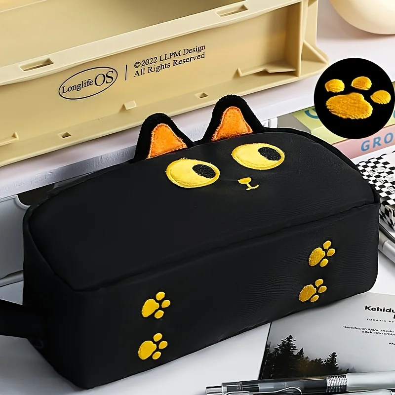 The Adorable 3D Cat Pencil Case by KittyNook Cat Co. is a cute stationery pouch with yellow ears and paw prints.