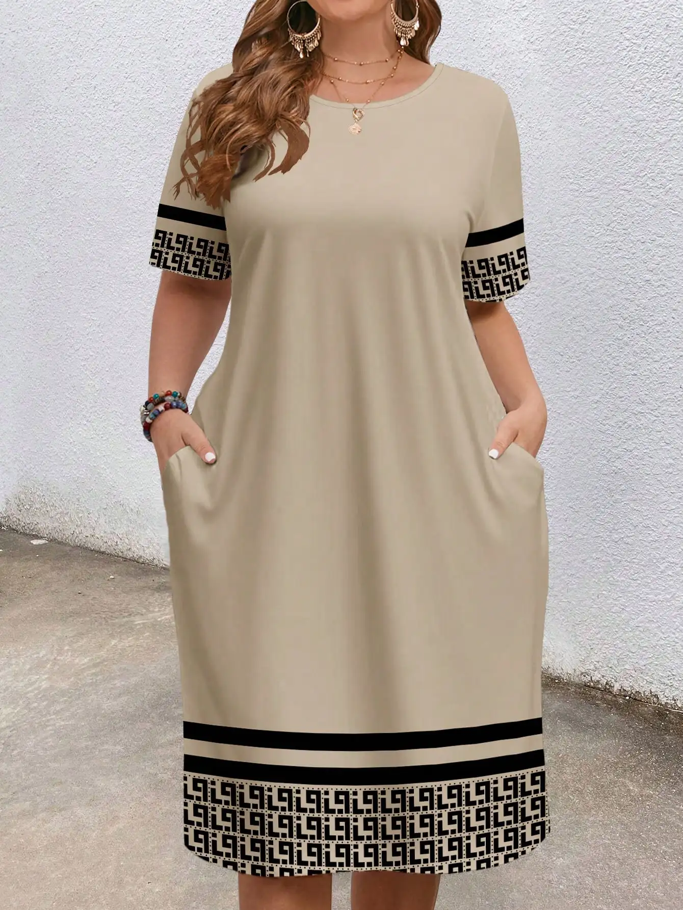 Plus-size women's short-sleeved round-neck pocket dress with geometric ethnic pattern print and loose fit.