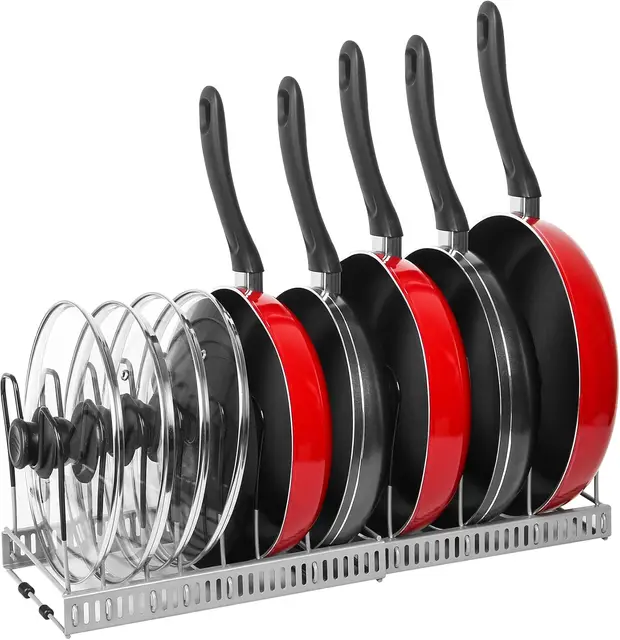 An expandable pot and pan organizer in a kitchen cabinet, neatly holding several frying pans and pot lids vertically.