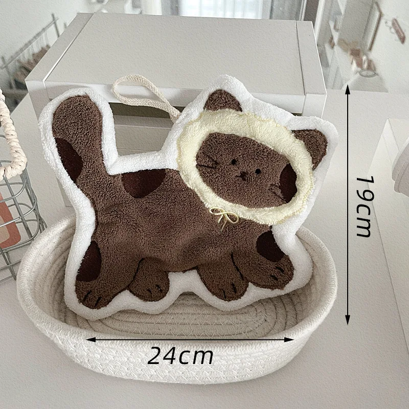 KittyNook Cat Co. Soft Cat Paw Hand Towel, 24x19cm, plush brown-spotted cat design displayed on table.