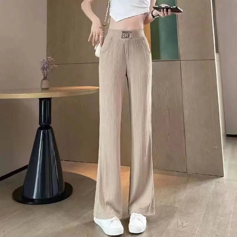 2024 Summer Women's New Spliced Elasticized High-waisted Fashion Solid Color Pocket Comfortable Minimalist Casual Flare Pants