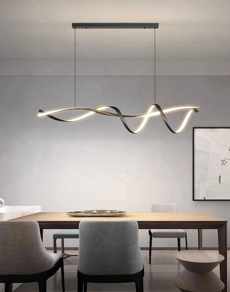 In a modern dining room, a wooden table and four chairs sit under the Stylish Pendant Light, featuring a wave-like design that embodies nature-inspired elegance. A framed abstract artwork adorns the gray wall, enhancing the contemporary aesthetic.
