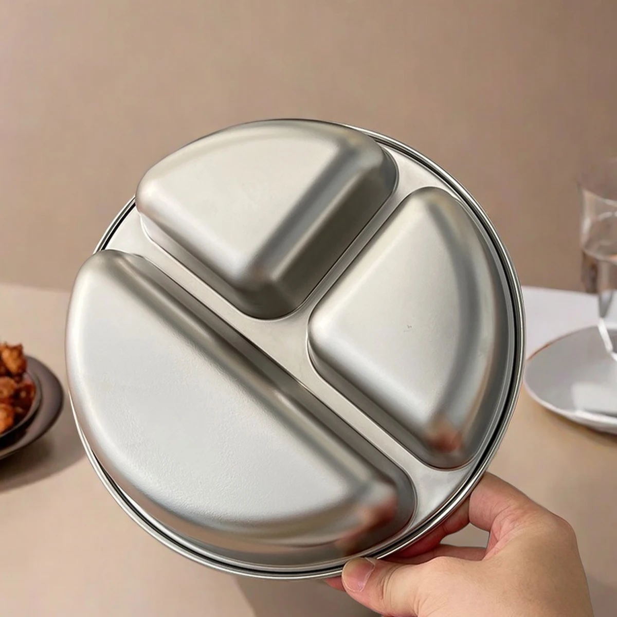 Durable and sleek round metal plate for professional catering.