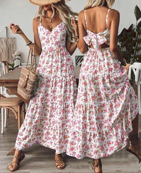 European style V-neck blue and white printed halter dress with back exposure and tie design for a flowing dress. Bohemian vacati