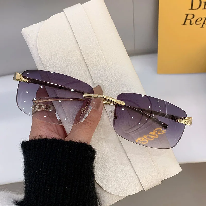 Stylish rimless rectangle sunglasses with tinted lenses and gold temples