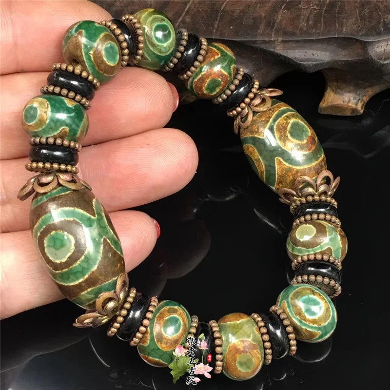

Tibetan old jade agate three-nine-eye dzi beads bracelet male and female barrel round beads Dong sculpture.