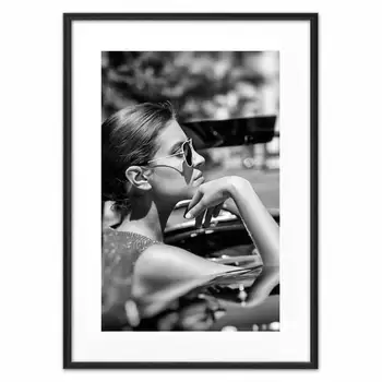 

Poster in the frame behind the wheel