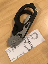 Tijeras de Respuesta de Emergencia Raptor 6 en 1, con cortador de Correa y interruptor de vidrio negro con funda Compatible con MOLLE