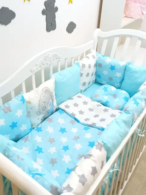 Set the bed, bed sheets, bumpers in the crib mamdis Light Blue