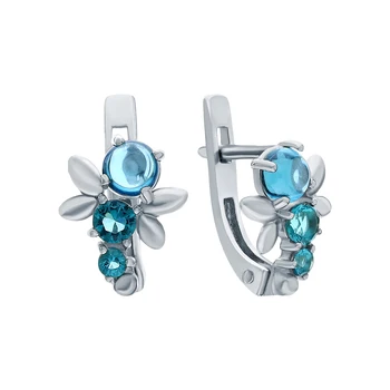 

Silver earrings with cubic zirconia and jewelry glasses sunlight