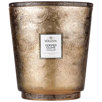 

Voluspa scented candle is a copper clove in a large candle holder with 5 Wicks