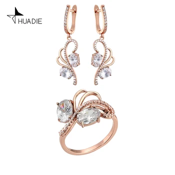 

HUADIE jewelry set for women. unusual long women's earrings with dangling pendants and a thin feather-shaped ring with stones.