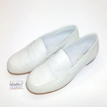 

Communion shoes for boy on beige leather