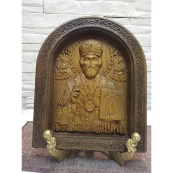 

Carved icon of Nicholas the Wonderworker in a rounded frame measuring 19-23 cm