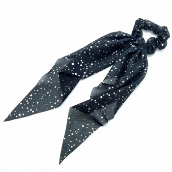 

Elastic hair band d color black with golden polka dots, female ponytail.