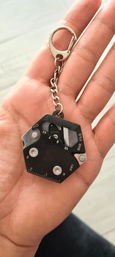 Customer holding the Multifunctional Hexagon Keychain Tool in the palm of hand,