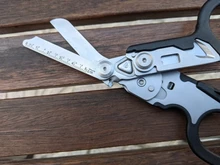 Tijeras de Respuesta de Emergencia Raptor 6 en 1, con cortador de Correa y interruptor de vidrio negro con funda Compatible con MOLLE